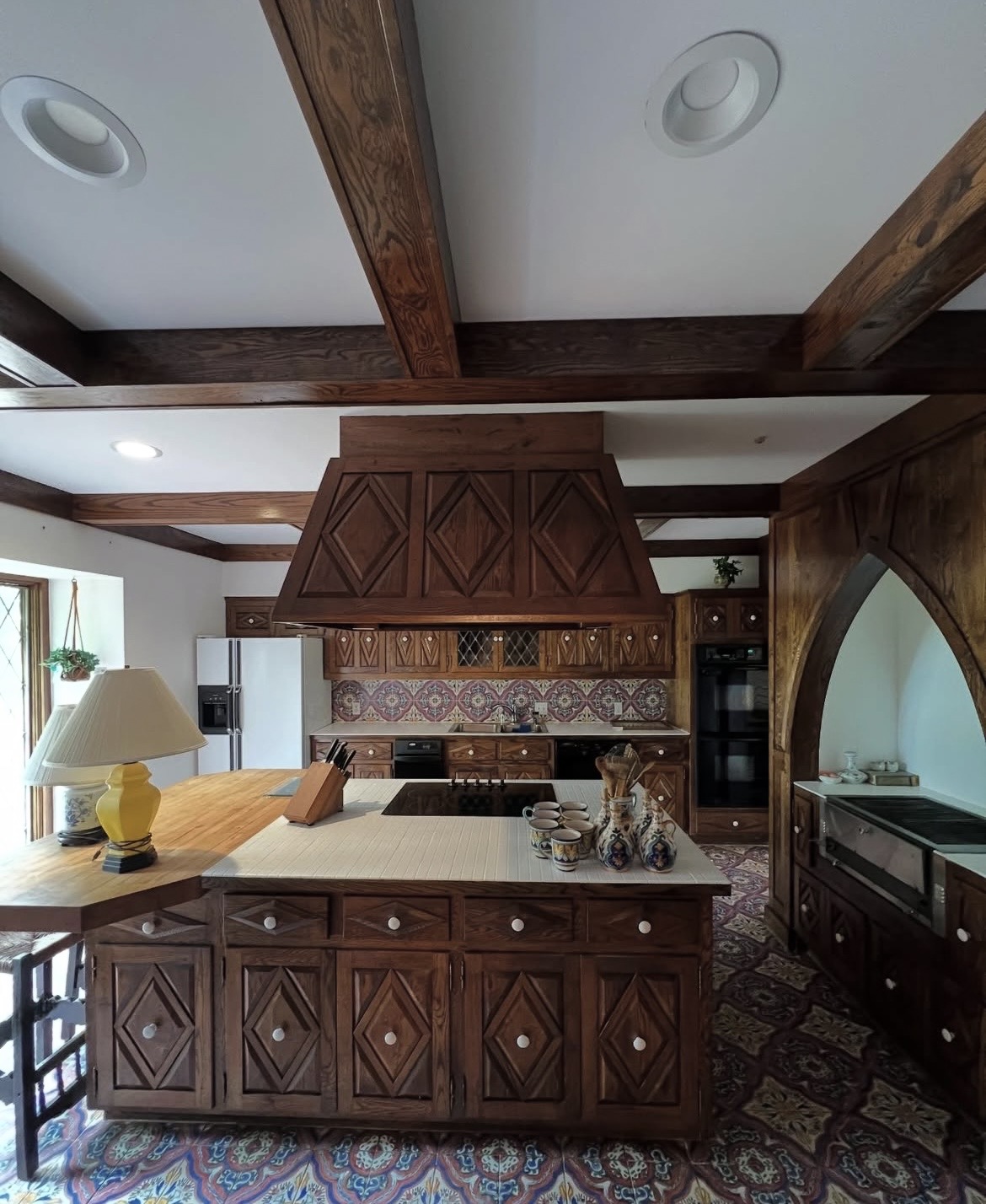 Detailed wood kitchen with a large central island and surrounding cabinetry